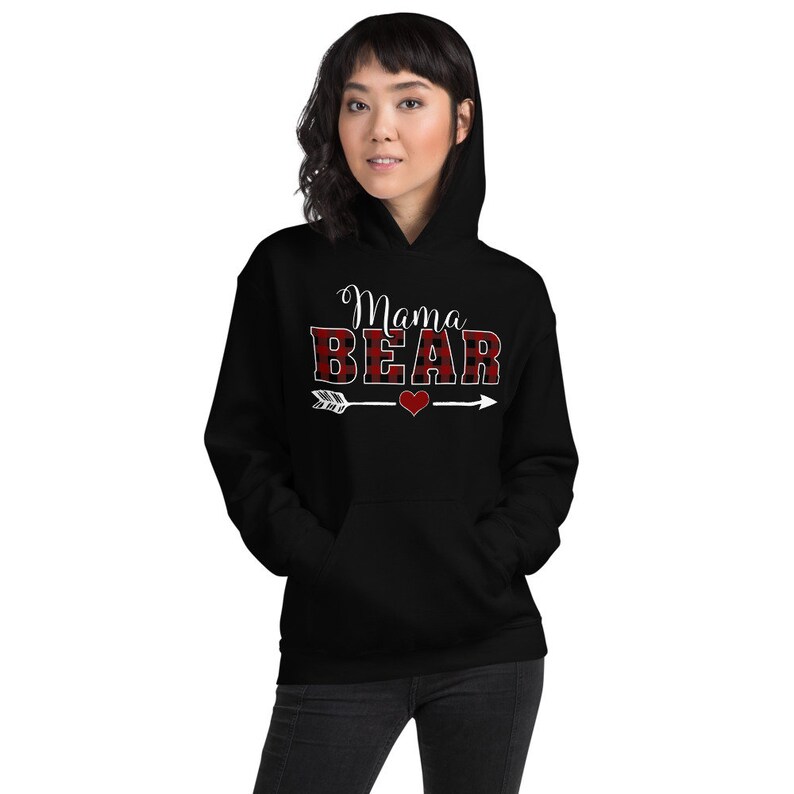 May include: Black hooded sweatshirt with the text "Mama Bear" in white letters with a red and black buffalo plaid pattern. An arrow with a heart is below the text.