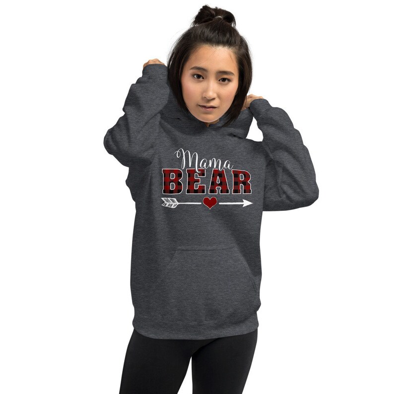 May include: A dark grey hooded sweatshirt with the text "Mama Bear" in white lettering. The word "Bear" is in red and black buffalo plaid.