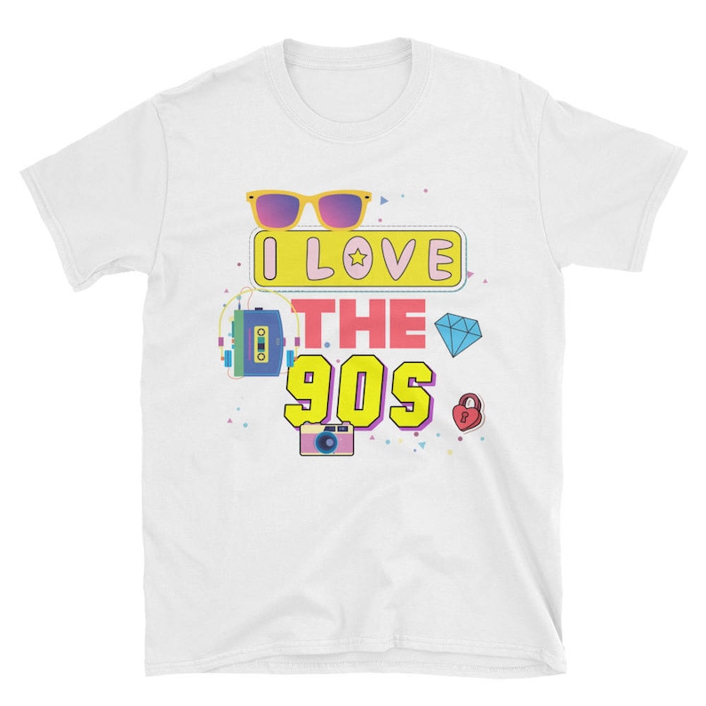 May include: White t-shirt with a colorful graphic design that says "I Love The 90s". The graphic includes sunglasses, a cassette tape, a camera, a diamond, and a heart.