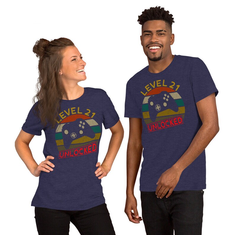 May include: Two navy blue t-shirts with a retro video game controller graphic and the text "Level 21 Unlocked".