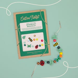 May include: A craft kit for making a Minibeast bracelet. The kit includes a green and brown card with the text "Cotton Twist" and "Make Your Own Minibeast Bracelet". The bracelet features wooden beads, leaves, butterflies, bees, and a ladybug.