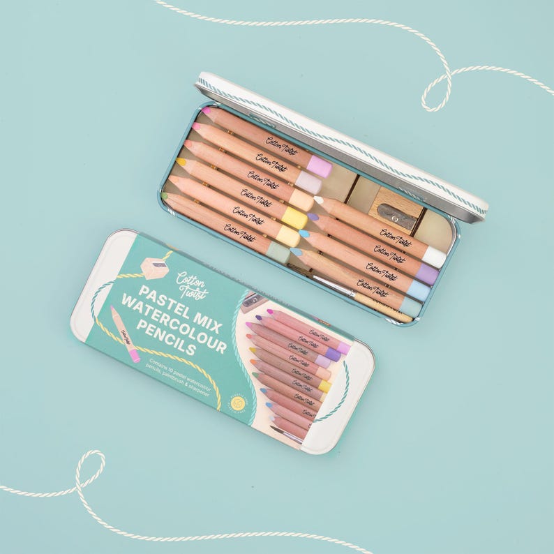 May include: Two pastel watercolour pencil sets in a light blue tin. One tin is open, revealing pencils with coloured tips and a pencil sharpener. The other tin is closed, with the words "Pastel Mix Watercolour Pencils" printed on the lid.