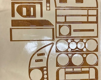 May include: A set of wood-grain interior trim pieces for a vehicle's dashboard and console. The pieces are various shapes and sizes, designed to fit specific areas. The logo "ARS cockpit design" is visible at the bottom.