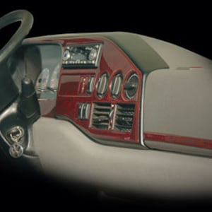 May include: A red woodgrain dashboard kit for a car interior. The kit includes a steering wheel, a centre console, and a dashboard.