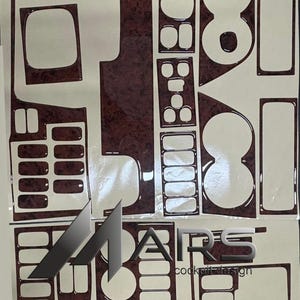 May include: A set of dark brown wood-grain patterned adhesive dashboard trim pieces arranged on a backing sheet. The individual decals feature various geometric shapes for vehicle interior controls, with the text MARS cockpit design visible.