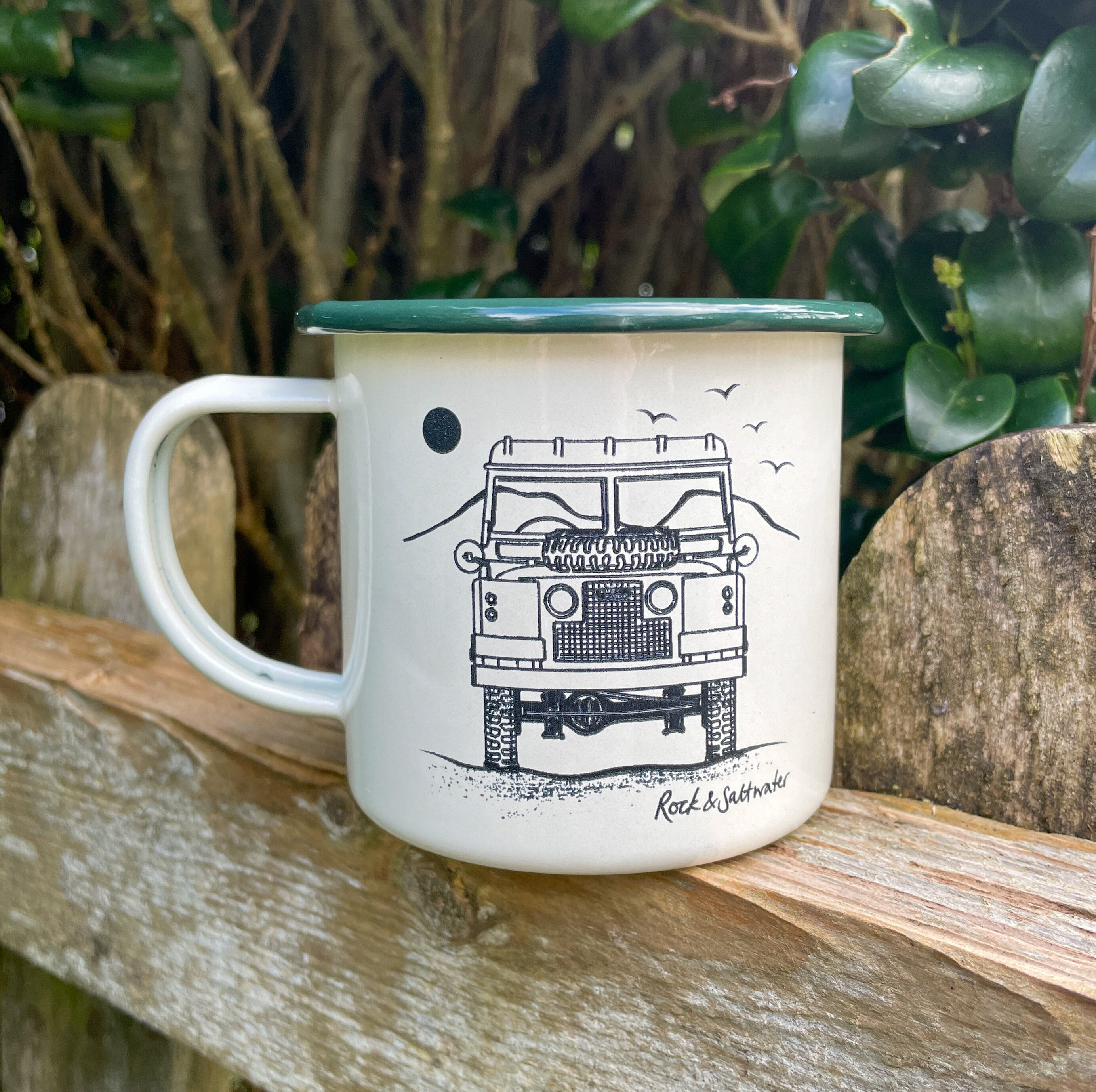 Land Rover front view with mountain.  Cream and green enamel mug – perfect camping mug or gift
