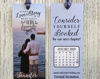 May include: A save the date card with a photo of a couple on the beach. The card is light blue with white text. The text says "Every love story is beautiful but ours is our favorite." and "Consider yourself booked for our next chapter!" The card also includes a calendar for January 2020 with the 25th circled. The bottom of the card says "Jennifer & Carlos 01.25.20 San Diego, CA" and "JanineAndCarlosWedding.com Formal Invitation to Follow."