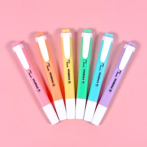 May include: A set of six pastel highlighter pens with white caps. The pens are labelled "STABILO Swing Cool" in black text. The colours of the highlighters are pink, orange, yellow, green, blue, and purple.
