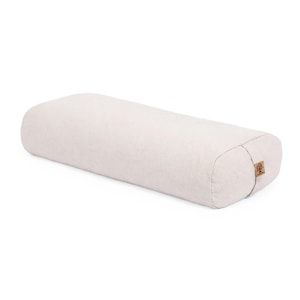 May include: A rectangular yoga bolster in a light beige, textured fabric. The bolster features rounded edges and a small, square brown cork label on the side panel, which displays a circular tree graphic and text.