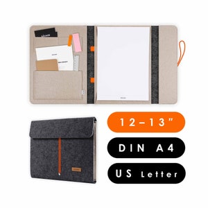 May include: A grey felt folder with an orange pull tab and a beige felt folder with a black and orange pull tab. The beige folder has a pocket for cards and a pocket for a ruler. The folders are open to reveal a blank white sheet of paper. The text "12-13"", "DIN A4", and "US Letter" is printed on the image.