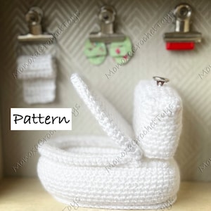 Può includere: Water closet bianco all'uncinetto con il coperchio aperto. Il water è una versione in miniatura di un water reale ed è fatto per essere un accessorio per case di bambole. La parola "Pattern" è scritta in nero su sfondo bianco.