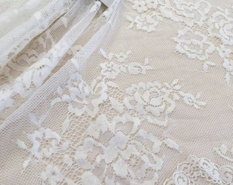 May include: White floral lace fabric with a delicate pattern. The fabric is sheer and has a soft, flowing texture. The label "Imperial Lace" is visible in the top right corner of the image.