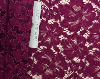 May include: Burgundy lace trim with a floral pattern. The trim is labeled "Imperial Lace".