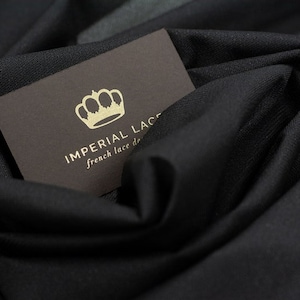 May include: A brown business card with a gold crown and the text "IMPERIAL LACE french lace de..."