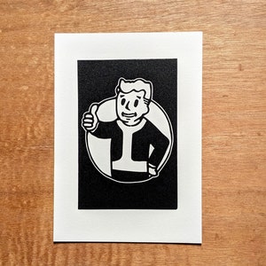 May include: Black and white illustration of a person giving a thumbs up. The person is wearing a jacket and has a circle around them.