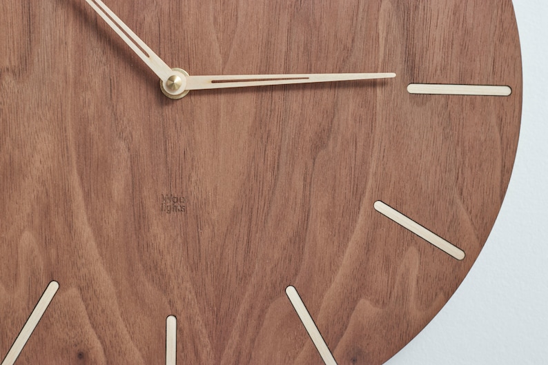 Mid century modern clock. Dark brown colour of the clock made of american walnut wood. This would perfectly fit to modern and minimalist like interior.