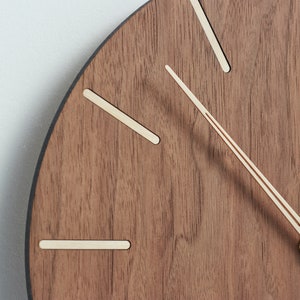 Wall clock made of american walnut wood. Shape of clock hands make reading time easy whilst ensuring the look of the clock to be great