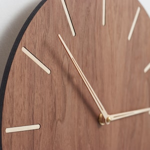 The edge of the clock is deep dark brown - almost black - in colour. It is nice accent which supplements warm brown clock face and light birch wood indexes.