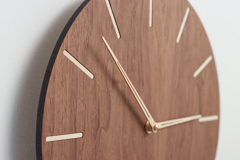 The edge of the clock is deep dark brown - almost black - in colour. It is nice accent which supplements warm brown clock face and light birch wood indexes.