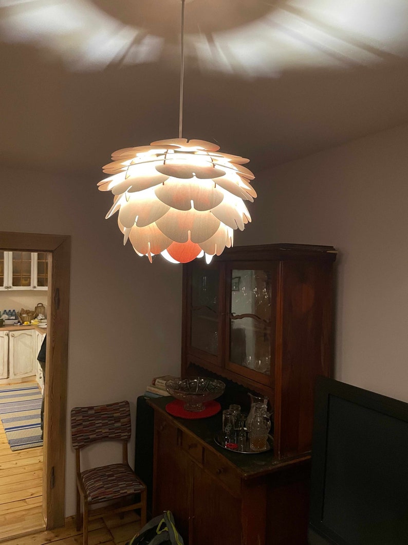 Small cosy room with  old wooden cupboard, chair and wood pendant light