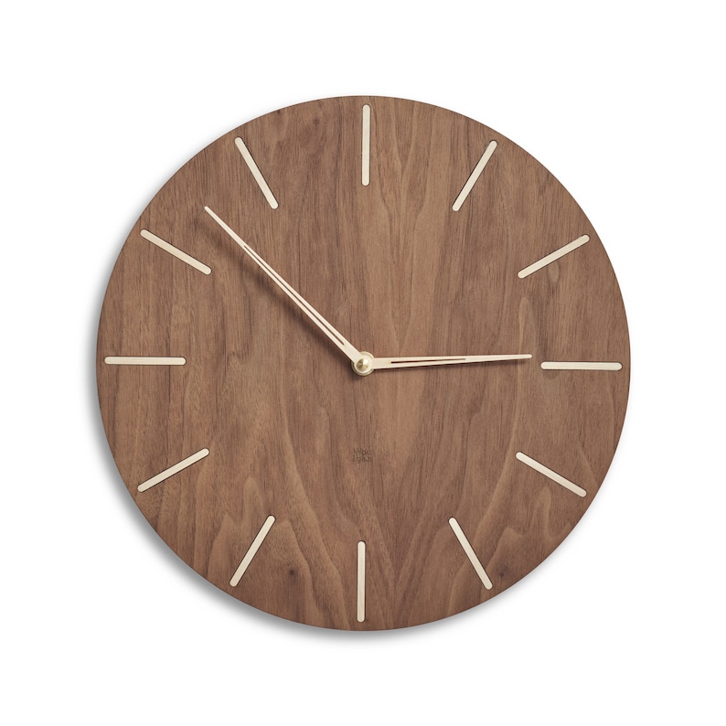 Mid century modern style wood wall clock made of american walnut and birch woods. Worm deep dark brown colour of the clock face contrasts with indexes made of birch wood. Clock hands are light coloured to mimic birch wood. Minimalist stylish design