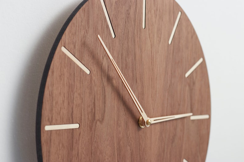 Wood wall clock made of american walnut. Minimalist design mid century modern wall clock. Easy to read the time. Equipped with a silent clock mechanism.The clock is perfect for bedroom, office or living room