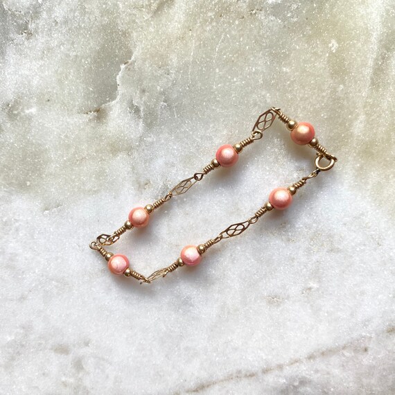 Peach Tassel Earrings with Celtic Knot Design Gold Tone Peach Tassel Earrings with Celtic Knot Design Gold Tone