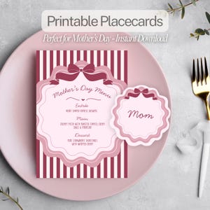 May include: A pink Mother's Day menu and place card set. The menu features a pink and white striped background with a decorative frame and bow. The place card has the word "Mom" on it. The text "Printable Placecards" is at the top.