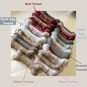 selection of examples of dog bone toys. mini and standard sizes, fabrics ( duck egg tweed, red tartan, duck egg tartan, pewter tweed , blush tweed and stone tweed. gold personalised embroidery.