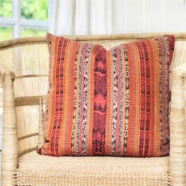 Vintage textile pillow in a bold orange and red ikat design. One-of-a-kind Guatemalan corte repurposed into a 20 x 20 throw cushion cover.