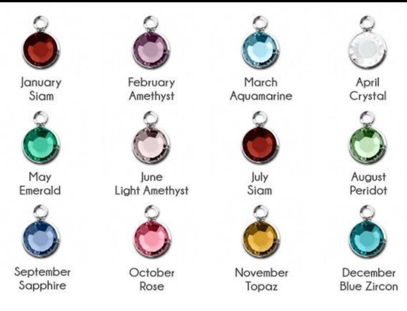 May include: Twelve round gemstone charms, each representing a different month of the year. The charms are silver with a clear crystal, red, pink, blue, green, and yellow gemstones.