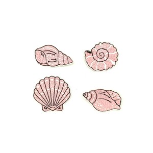 May include: Four pink embroidered iron-on patches of seashells. The patches include a conch shell, a scallop shell, and two different types of spiral shells.