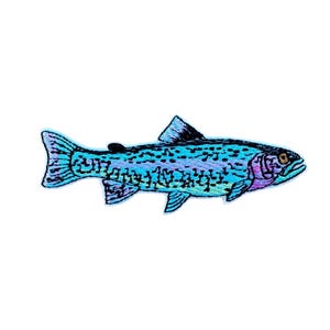 May include: Embroidered patch of a fish in shades of blue, purple, and black. The fish has a detailed design with a brown eye and black dorsal fin. Suitable for application on clothing or accessories.