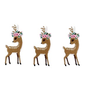 May include: Three identical embroidered patches, each depicting a brown deer with white spots on its back. Each deer features a floral crown of pink roses and green leaves between its antlers, with dark brown legs and a white tail.