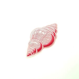 May include: A pink embroidered seashell patch. The shell is curled and has a white outline.