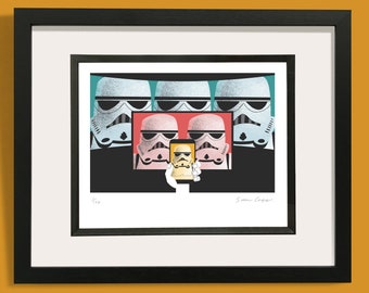 May include: A framed print of a digital illustration featuring five Stormtrooper helmets from Star Wars. The Stormtrooper in the center is holding a smartphone and taking a selfie. The print is signed "Simon Cogger" and numbered "1/100".