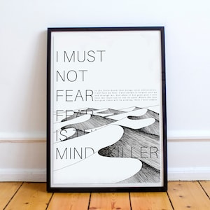 May include: Black and white print with the text "I must not fear. Fear is the mind killer." The text is overlaid on a drawing of sand dunes.