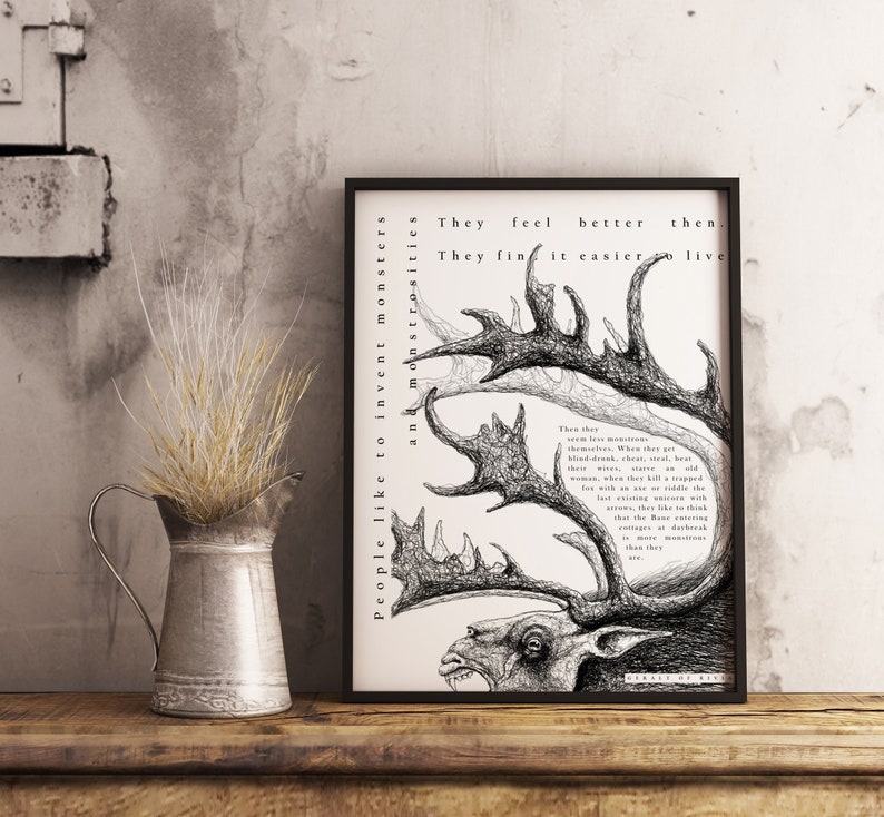 May include: A framed black and white art print featuring a detailed illustration of a deer-like creature with large antlers. The artwork includes text that reads "People like to invent monsters and monstrosities."