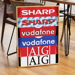 May include: A framed poster with a red, white, and blue color scheme. The poster features the logos of several companies, including Sharp, Vodafone, and AIG.