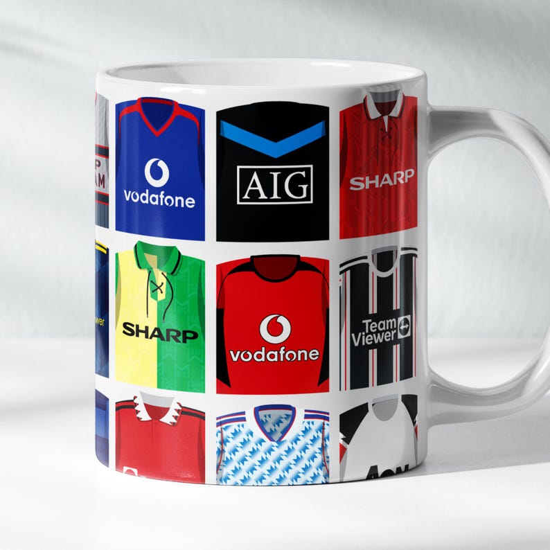May include: White ceramic mug with a design of different soccer jerseys from the 1990s. The jerseys feature logos for sponsors like Vodafone, Sharp, and AIG.