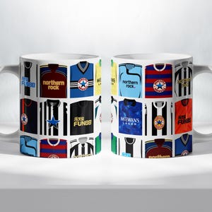 May include: A white ceramic mug with a collage of colorful soccer jerseys printed on it. The jerseys feature various team logos, sponsors, and numbers. The text on the mug includes "FUNBB", "northern rock", "MSEWAN'S LAGER", and "乐天堂 FUN88".
