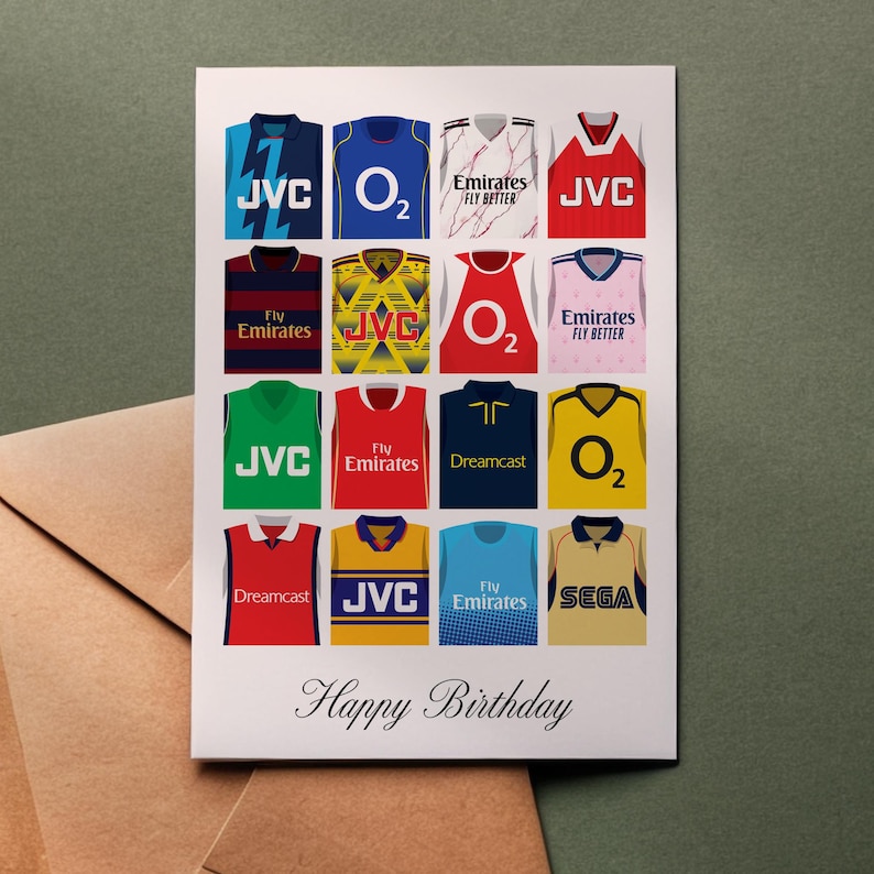 May include: A white card with a collage of 16 different football jerseys. Each jersey has a different sponsor logo, including JVC, O2, Emirates, Sega, and Dreamcast. The text "Happy Birthday" is printed at the bottom of the card.