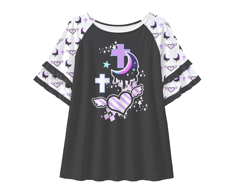 May include: A black raglan shirt with white tiered bell sleeves featuring a repeating pattern of purple crescent moons and winged hearts. The centre graphic displays a purple dripping crescent moon, two light blue crosses, and a striped winged heart.