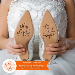 May include: A pair of white bridal shoes with a brown sole. The soles have black lettering that reads "Of all our walks" and "This one is my favourite!"  The shoes are held by a person's hands. The image includes a logo for "Cake Walk Collective" and the text "Effortless Application. Our decals come with instructions and all needed materials, making it simple to enhance your shoes with minimal effort."