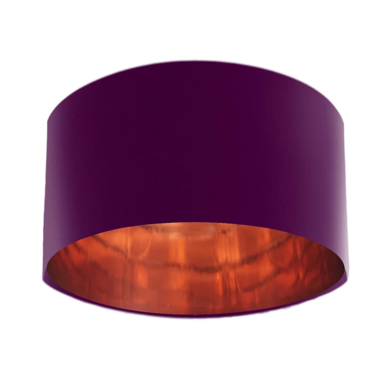 May include: A cylindrical lampshade in a deep purple hue, featuring a copper-coloured interior. The lampshade has a smooth, solid colour finish. Its simple, modern design makes it suitable for a variety of interior settings.