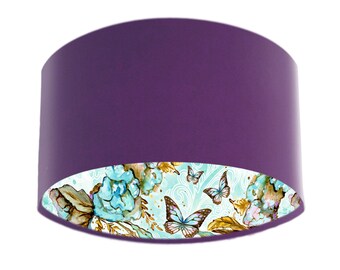 May include: A purple lampshade with a white and blue floral and butterfly design on the inside.