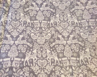 May include: Gray fabric with a white repeating pattern of stylized reindeer, birds, trees, and stars. The pattern is reminiscent of Scandinavian folk art.