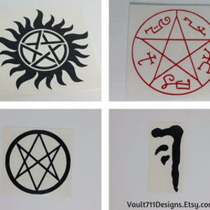 May include: Four black and white vinyl decals featuring symbols from the TV show Supernatural. The first decal is a pentagram with a sunburst behind it. The second decal is a pentagram with runes around it. The third decal is a pentagram inside a circle. The fourth decal is a symbol that looks like a stylized letter 'J'.