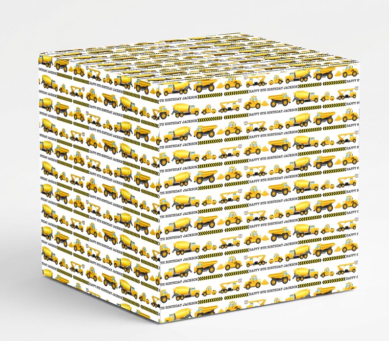 May include: White gift box wrapped in paper with a repeating pattern of yellow construction vehicles. The design includes dump trucks, cement mixers, and excavators. The text "HAPPY 8TH BIRTHDAY JACKSON" is also printed on the paper.