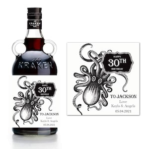 May include: A black and white label featuring an octopus illustration with the text "Happy 30th Birthday" and "To Jackson Love Kayla & Angela 05.04.2021". The label is attached to a bottle of Kraken Black Spiced Rum.